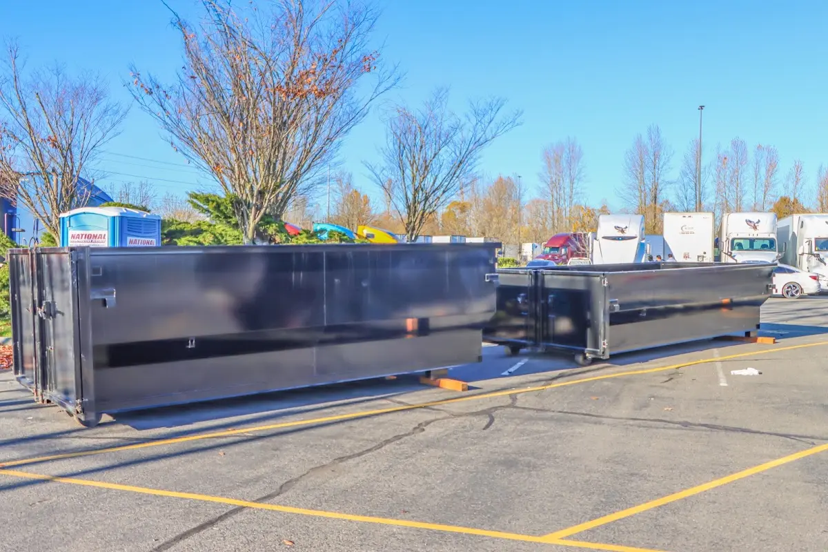 Professional dumpster rental service with roll-off container on residential driveway in Franklin Farm